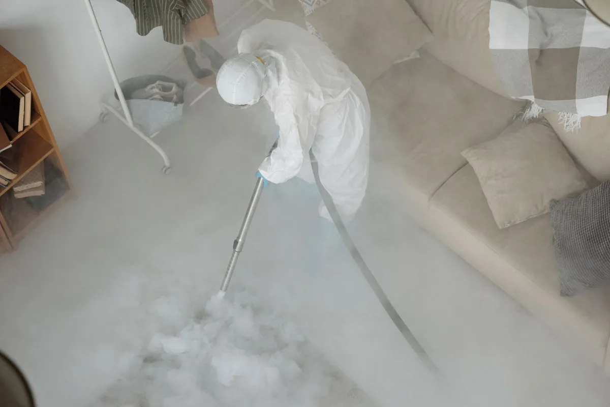 Biohazard cleanup technician in protective equipment, Terre du Lac, MO